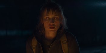 Movie still from “Blood Red Sky” (2021), directed by Peter Thorwarth – A woman in a dark room looking at the camera; Close Up shot, Low angle
