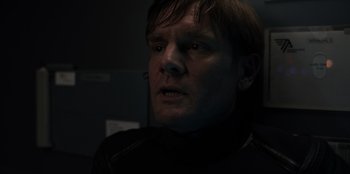 Movie still from “Blood Red Sky” (2021), directed by Peter Thorwarth – A person wearing a black jacket; Close Up shot, Over the shoulder angle