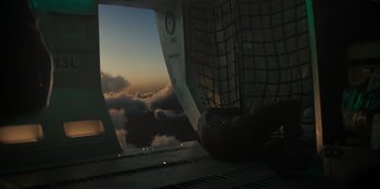 Movie still from “Blood Red Sky” (2021), directed by Peter Thorwarth – A view from inside an airplane looking out the window at sunset; Extreme Wide shot, Overhead angle