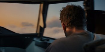 Movie still from “Blood Red Sky” (2021), directed by Peter Thorwarth – A man sitting in the driver's seat of an airplane; Close Up shot, Low angle