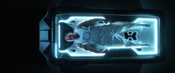 Movie still from “Bloodshot” (2020), directed by Dave Wilson – A man is in an operating room with a lamp; Medium shot, Overhead angle