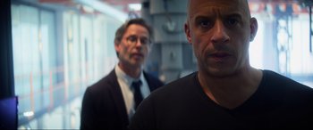 Movie still from “Bloodshot” (2020), directed by Dave Wilson – Two men standing next to each other in front of a wall; Close Up shot, Over the shoulder angle