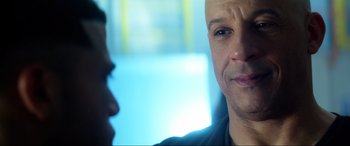 Movie still from “Bloodshot” (2020), directed by Dave Wilson – A man with a shaved head is talking to another man; Close Up shot, Over the shoulder angle