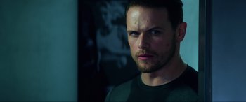 Movie still from “Bloodshot” (2020), directed by Dave Wilson – A person wearing a green shirt; Close Up shot, Over the shoulder angle