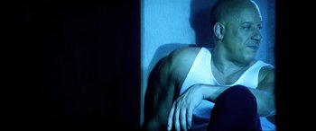 Movie still from “Bloodshot” (2020), directed by Dave Wilson – A man sitting on a bed in a dark room; Medium shot, Low angle