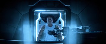 Movie still from “Bloodshot” (2020), directed by Dave Wilson – A man sitting inside of an enclosed space ship; Medium shot, Overhead angle