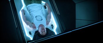 Movie still from “Bloodshot” (2020), directed by Dave Wilson – A man is laying down in an enclosed room; Medium shot, Overhead angle