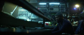 Movie still from “Bloodshot” (2020), directed by Dave Wilson – A man sitting in front of a computer monitor; Medium shot, Low angle