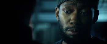 Movie still from “Bloodshot” (2020), directed by Dave Wilson – A person with a beard; Close Up shot, Over the shoulder angle