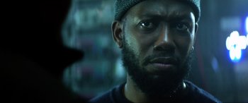 Movie still from “Bloodshot” (2020), directed by Dave Wilson – A person with a beard wearing a hat; Close Up shot, Low angle