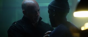 Movie still from “Bloodshot” (2020), directed by Dave Wilson – Two men talking in front of each other in a room; Close Up shot, Over the shoulder angle