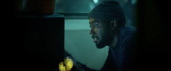 Movie still from “Bloodshot” (2020), directed by Dave Wilson – A man looking at a computer screen while sitting in front of it; Close Up shot, Over the shoulder angle