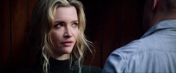 Movie still from “Bloodshot” (2020), directed by Dave Wilson – A person with long blonde hair; Close Up shot, Over the shoulder angle