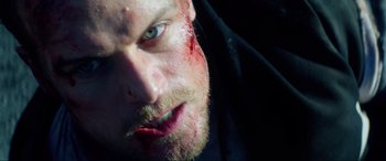 Movie still from “Bloodshot” (2020), directed by Dave Wilson – A person with blood all over his face; Extreme Close Up shot, Overhead angle