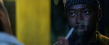Movie still from “Bloodshot” (2020), directed by Dave Wilson – A person holding a cigarette in his mouth; Close Up shot, Over the shoulder angle