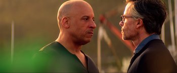 Movie still from “Bloodshot” (2020), directed by Dave Wilson – A man with a bald head talking to another man; Close Up shot, Over the shoulder angle