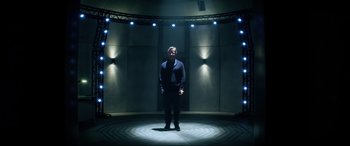 Movie still from “Bloodshot” (2020), directed by Dave Wilson – A man standing in the middle of a stage lit up with lights; Wide shot, Low angle