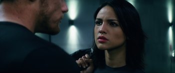 Movie still from “Bloodshot” (2020), directed by Dave Wilson – A woman looking into a mirror while a man holds a pair of scissors; Close Up shot, Over the shoulder angle