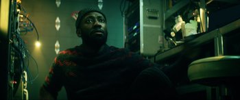 Movie still from “Bloodshot” (2020), directed by Dave Wilson – A man sitting in front of a computer monitor; Close Up shot, Low angle