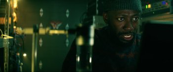 Movie still from “Bloodshot” (2020), directed by Dave Wilson – A person sitting in front of a microphone; Close Up shot, Low angle