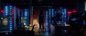 Movie still from “Bloodshot” (2020), directed by Dave Wilson – A woman standing in a room with lights in the background; Wide shot, Over the shoulder angle