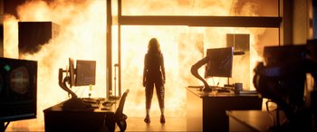 Movie still from “Bloodshot” (2020), directed by Dave Wilson – A woman standing in front of a fire; Wide shot, Low angle