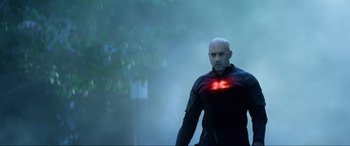 Movie still from “Bloodshot” (2020), directed by Dave Wilson – A man in a black jacket is standing in the fog; Medium shot, Low angle