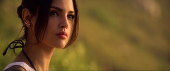 A woman's face in front of a blurry background
