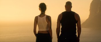 Movie still from “Bloodshot” (2020), directed by Dave Wilson – A man and a woman standing next to each other on the beach; Medium shot, Low angle