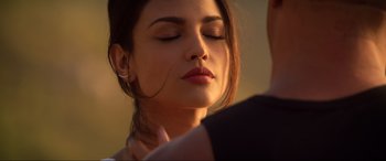 Movie still from “Bloodshot” (2020), directed by Dave Wilson – A beautiful young woman with her eyes closed; Close Up shot, Over the shoulder angle