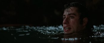 Movie still from “Blow Out” (1981), directed by Brian De Palma – A man in the water looking up at the sky; Close Up shot, Low angle