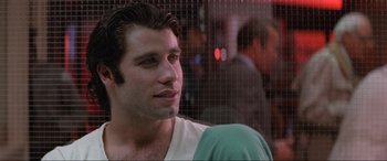 Movie still from “Blow Out” (1981), directed by Brian De Palma – A person wearing a white t - shirt; Close Up shot, Over the shoulder angle