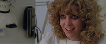 Movie still from “Blow Out” (1981), directed by Brian De Palma – A person with curly blonde hair; Close Up shot, Low angle