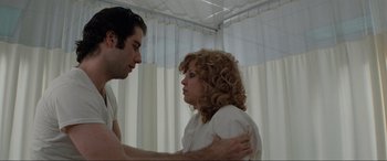 Movie still from “Blow Out” (1981), directed by Brian De Palma – A man and a woman in a white room; Medium shot, Low angle