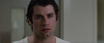 Movie still from “Blow Out” (1981), directed by Brian De Palma – Close up of a man's face in a white shirt; Close Up shot, Over the shoulder angle