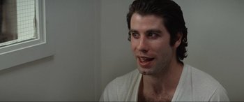 Movie still from “Blow Out” (1981), directed by Brian De Palma – A person wearing a white shirt; Close Up shot, Over the shoulder angle