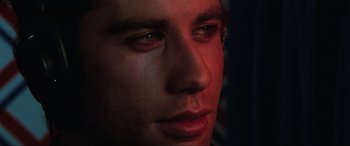 Movie still from “Blow Out” (1981), directed by Brian De Palma – A man's face in the dark; Extreme Close Up shot, Low angle