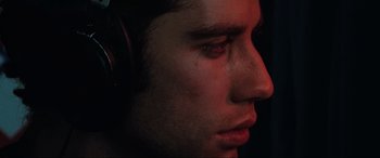 Movie still from “Blow Out” (1981), directed by Brian De Palma – A person with headphones on; Extreme Close Up shot, Low angle