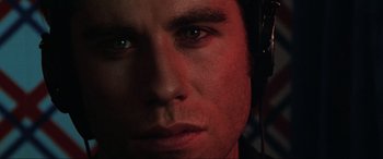 Movie still from “Blow Out” (1981), directed by Brian De Palma – A man's face wearing headphones; Extreme Close Up shot, Overhead angle