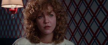 Movie still from “Blow Out” (1981), directed by Brian De Palma – A person with curly red hair; Close Up shot, Low angle