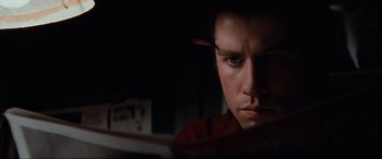 Movie still from “Blow Out” (1981), directed by Brian De Palma – A person looking at a tablet; Close Up shot, High angle