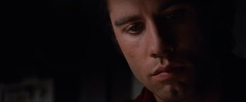 Movie still from “Blow Out” (1981), directed by Brian De Palma – A man's face in the dark; Close Up shot, Low angle