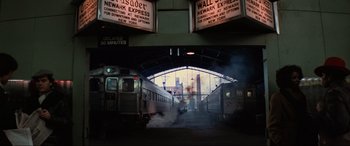 Movie still from “Blow Out” (1981), directed by Brian De Palma – A train station with two trains on the tracks; Extreme Wide shot, High angle