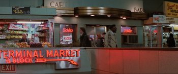 Movie still from “Blow Out” (1981), directed by Brian De Palma – A group of people walking in front of a store; Wide shot, High angle