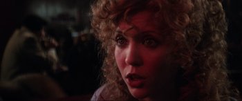 Movie still from “Blow Out” (1981), directed by Brian De Palma – A person with curly hair; Close Up shot, Over the shoulder angle