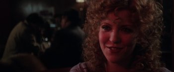Movie still from “Blow Out” (1981), directed by Brian De Palma – A person with curly red hair; Close Up shot, Over the shoulder angle