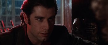 Movie still from “Blow Out” (1981), directed by Brian De Palma – A person sitting in a chair; Close Up shot, Over the shoulder angle