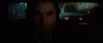 Movie still from “Blow Out” (1981), directed by Brian De Palma – A person wearing headphones in the dark; Close Up shot, Over the shoulder angle