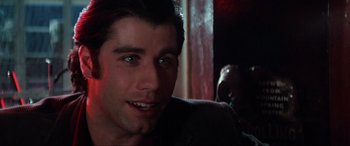 Movie still from “Blow Out” (1981), directed by Brian De Palma – A person smiling at the camera; Close Up shot, Over the shoulder angle