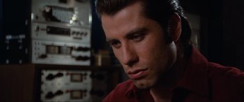Movie still from “Blow Out” (1981), directed by Brian De Palma – A person wearing a red shirt; Close Up shot, Over the shoulder angle